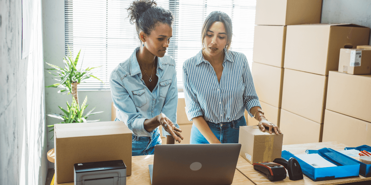 Two female business owners packing orders